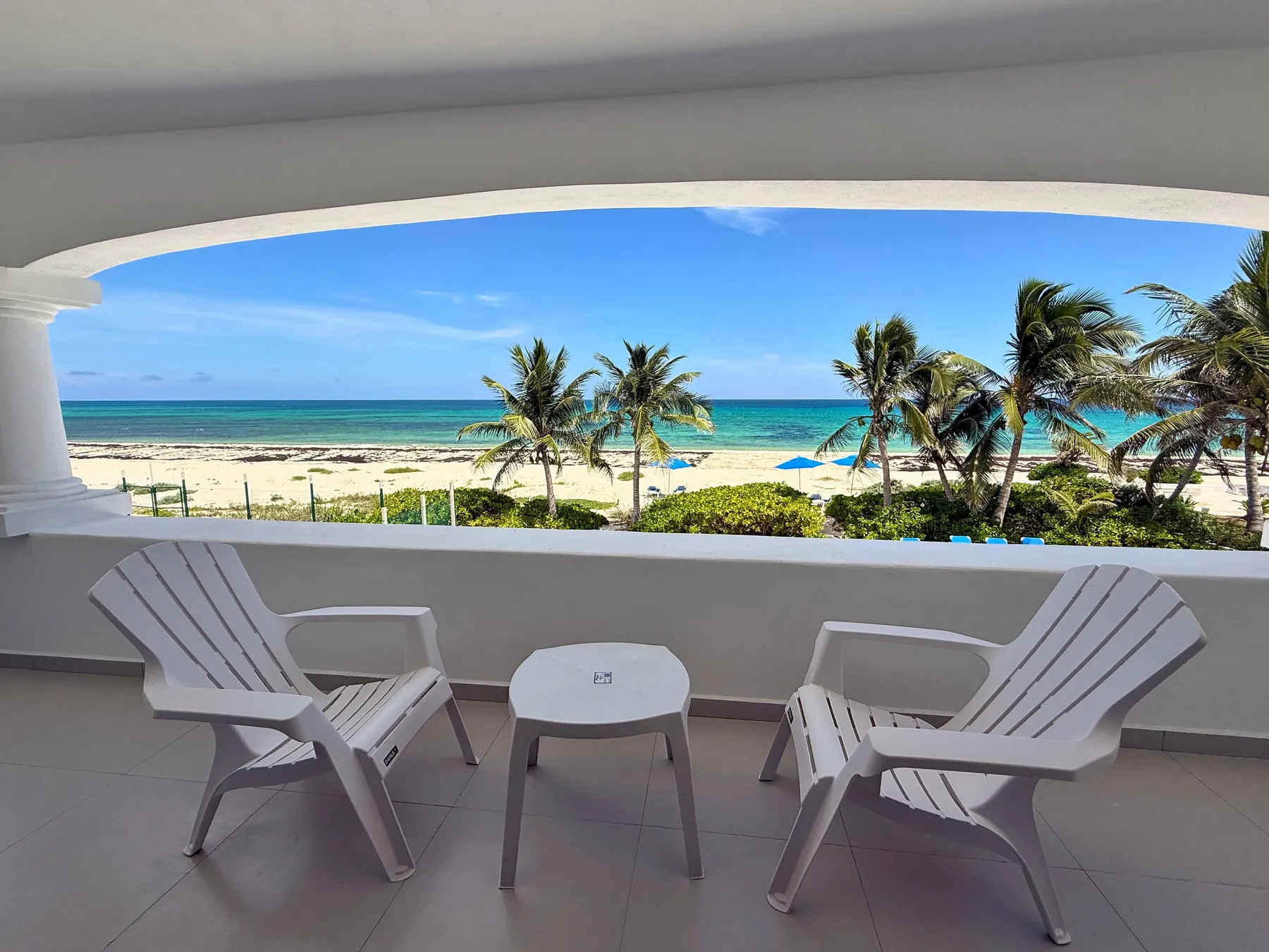 Arched terrace looking over palms to the sea